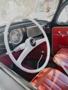 Renovated interior of a vintage car with red leather seats and a white steering wheel Royalty Free Stock Photo