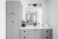 A bathroom detail with a grey cabinet and white countertop. Royalty Free Stock Photo