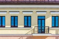 Renovated old building facade with rows of windows and balconyÃÅ½ closeup view