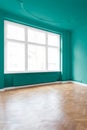 Room with green walls and parquet floor