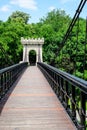 Renovated suspended metallic bridge in Nicolae Romaescu park from Craiova in Dolj county, Romania, in a beautiful sunny spring day