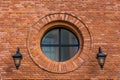 Renovated wall of an old textile factory with round window and two lanterns Royalty Free Stock Photo