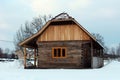 Renovated wooden log cottage surrounded with snow