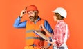 Renovation concept. Price list. Couple look documents. Woman and man safety hard hat. Couple planning changes renovation Royalty Free Stock Photo