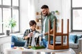 father and son applying solvent to tissue at home