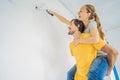 renovation diy paint couple in new home painting wall Royalty Free Stock Photo