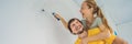 renovation diy paint couple in new home painting wall BANNER, LONG FORMAT Royalty Free Stock Photo