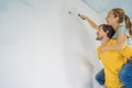 renovation diy paint couple in new home painting wall Royalty Free Stock Photo