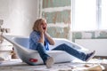 Renovation home. Excited shocked surprised woman sits in bathtub in the middle of the room. Empty walls, repairs house Royalty Free Stock Photo