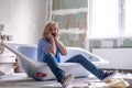 Renovation home. Excited shocked surprised woman sits in bathtub in the middle of the room. Empty walls, repairs house Royalty Free Stock Photo