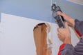 Home Interior damage for drywall board with repair home of man cutting plasterboard on using angle hand electric power tools