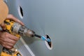 In renovation of a house cable will be laid by drilling holes in wall to beams in order to lay it Royalty Free Stock Photo