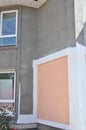 Renovation house paint walls outdoors. Painting house wall exterior. Unfinished house plastering and painting walls outdoor