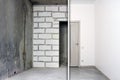 Before and after renovation in new housing. Empty room with concrete walls without finishing and the apartment is renovated Royalty Free Stock Photo