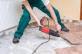 Renovation of old floor. Demolition of old tiles with jackhammer