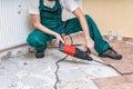 Renovation of old floor. Demolition of old tiles with jackhammer Royalty Free Stock Photo