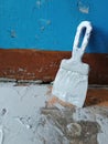 Renovation of old premises. Spatula in glue stands near old blue embossed wall. Laying floor tiles.Tile adhesive applied