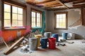 Renovation in Progress: Focus on Paint and Primer Jerry Buckets Amid Construction Materials Scattered