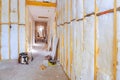 Renovation progress in an unfinished hallway insulation construction tools at residential space Royalty Free Stock Photo