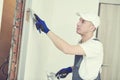 Refurbishment. Worker spackling a wall with putty Royalty Free Stock Photo
