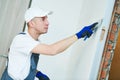 Refurbishment. Worker spackling a wall with putty