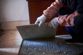 A renovation worker laying floor tiles at a renovation site Royalty Free Stock Photo