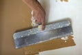 Renovation workers hand plastering the wall