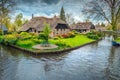 Dutch village with colorful ornamental garden and spring flowers, Giethoorn