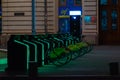 Rent a bike from the bicycle parking lot at night, in George Enescu Square in Bucharest, Romania Royalty Free Stock Photo