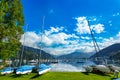 Rent-a-boat service in park at Zeller See lake. Zell Am See, Austria, Europe. Boats on shore and in water. Alps at background. Royalty Free Stock Photo
