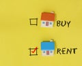 Rent and Buy checkbox on yellow background with miniature house.