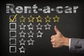 Rent-a-car five 5 star rating. thumbs up service golden rating stars on chalkboard Royalty Free Stock Photo