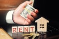 Rent a house online. concept of real estate. model of the house, keys, dollars and the inscription