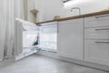 Rent of modern housing sale of new apartment, modern renovation. White furniture with utensils, shelves with crockery and plants