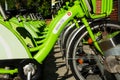 Rentable green city bicycles stored in a row. diminishing perspective