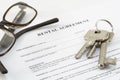 Rental agreement document with a set of house keys and glasses Royalty Free Stock Photo