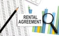 RENTAL AGREEMENT text on white card on the chart background