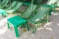 Rental beach canvas chairs and green table on natural white sand Royalty Free Stock Photo