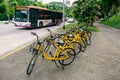 Rental bicycles parked by footpath