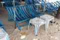 Rental blue beach canvas chairs and white table under colorful u Royalty Free Stock Photo