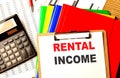 RENTAL INCOME text written on paper clipboard with chart and calculator Royalty Free Stock Photo