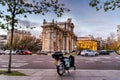 Rental motorbike in Puerta de Alcala in Madrid at sunset during Christmas