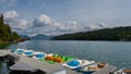 Rental pedal boats on pier at mountain lake Walchensee in Bavaria, Germany on sunny day with boat house Royalty Free Stock Photo