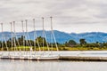 Rental sailing boats lined up on a pier in South San Francisco bay area, Shoreline Lake and Park; Santa Cruz mountains visible in Royalty Free Stock Photo