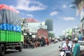 A Reog Ponorogo parade accompanied by trucks