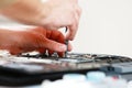 Repaiman with screwdriver fixing disassembled laptop parts. Technical support and fixing gadgets problems. Servicing Royalty Free Stock Photo