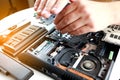 Repaiman with screwdriver fixing disassembled laptop parts. Technical support and fixing gadgets problems. Servicing Royalty Free Stock Photo