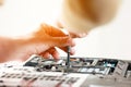 Repaiman with screwdriver fixing disassembled laptop parts. Technical support and fixing gadgets problems. Servicing Royalty Free Stock Photo