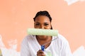 Repair in the apartment. Happy young woman paints the wall with paint, close-up. Royalty Free Stock Photo