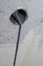 repair in the apartment. wires stick out of a hole in a concrete wall. The owner of the house is waiting for an electrician